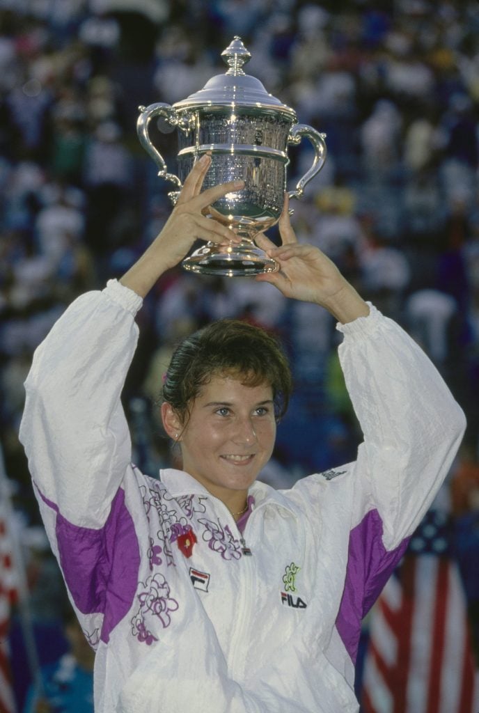 Monica Seles from Yugoslavia holds the trophy aloft to clebrate winning the Women's Singles Final match of the US Open Tennis Championship against Arantxa SÃ¡nchez Vicario on 12th September 1992 at the USTA National Tennis Center in New York City, New York, United States. 