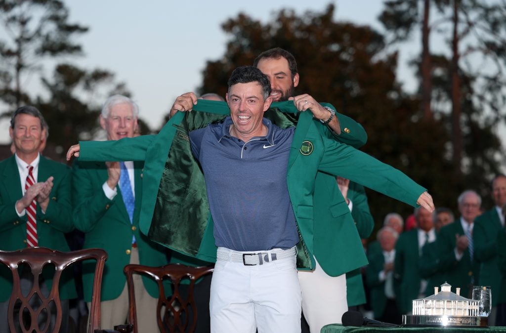 Rory McIlroy of Northern Ireland is awarded the Green Jacket by Masters Champion Scottie Scheffler after the final round of the 2025 Masters Tournament at Augusta National Golf Club on April 13, 2025 in Augusta, Georgia.
