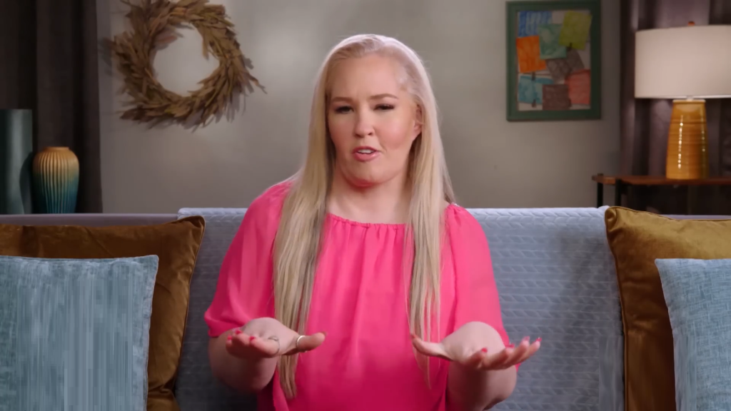 June Shannon in a pink blouse.