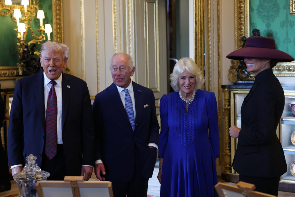 President Donald Trump, King Charles III, Queen Camilla and First Lady Melania Trump view items on display during a visit to the Royal Collection exhibition, in the Green Drawing Room during the State visit by the President of the United States of America at Windsor Castle on September 17, 2025 in Windsor, England. 