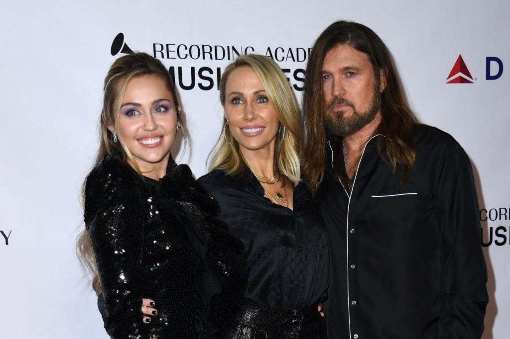 Miley Cyrus and parents Tish and Billy Ray Cyrus arrive for the 2019 MusiCares Person Of The Year gala at the Los Angeles Convention Center in Los Angeles on February 8, 2019.