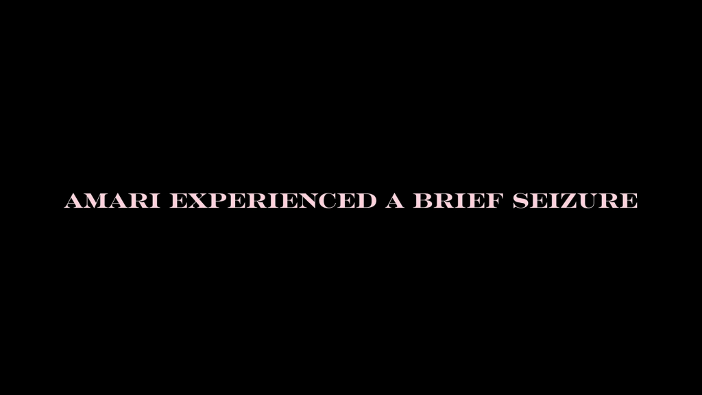 A title card with pink writing revealing that Amari experienced a seizure.