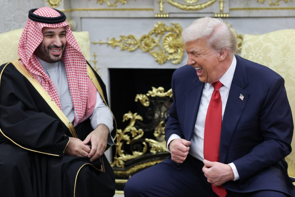 U.S. President Donald Trump (R) jokes with Crown Prince and Prime Minister Mohammed bin Salman of Saudi Arabia during a bilateral meeting in the Oval Office of the White House on November 18, 2025 in Washington, DC. 