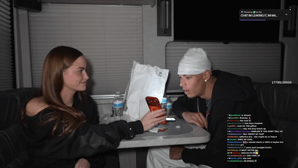 Haley Kalil holds her phone for Marlon Garcia to read.