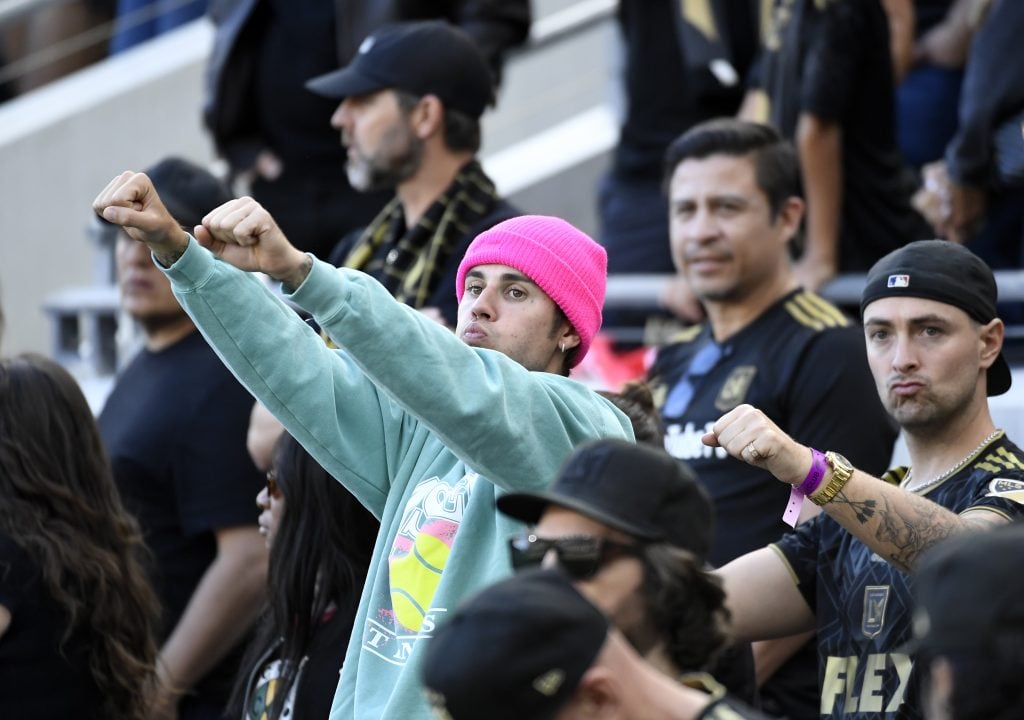 Justin Bieber puts his arms in the air in November of 2022.