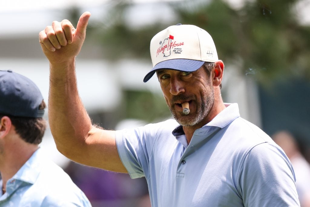 NFL football player Aaron Rodgers gives a thumbs up to the crowd at the 15th hole on day one of the 2024 American Century Championship at Edgewood Tahoe Golf Course on July 12, 2024 in Stateline, Nevada.