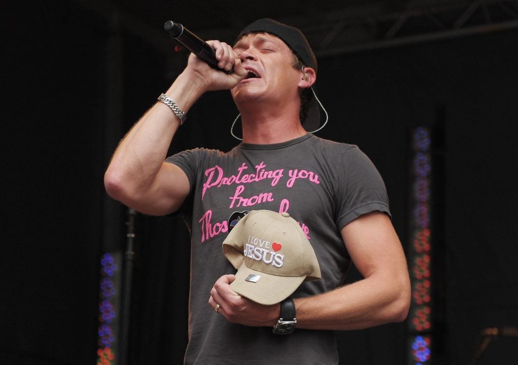 Brad Arnold of 3 Doors Down holds a fan's I Love Jesus hat while the band performs on FOX and Friends outside of FOX Studios on July 29, 2011 in New York City. 