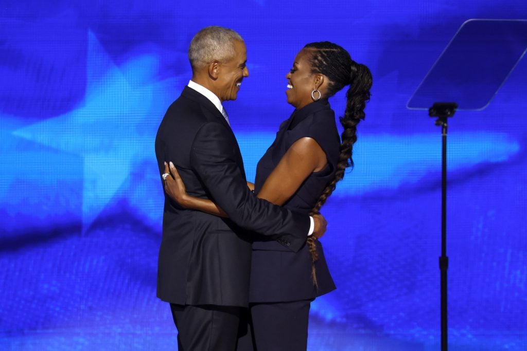Former U.S. President Barack Obama greets former first lady Michelle Obama as he arrives to speak on stage during the second day of the Democratic National Convention at the United Center on August 20, 2024 in Chicago, Illinois.