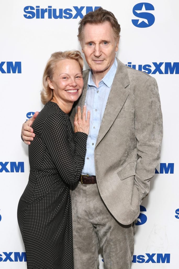 Pamela Anderson and Liam Neeson attend SiriusXM's Town Hall with the cast of The Naked Gun hosted by Andy Cohen at SiriusXM Studios on July 30, 2025 in New York City. 