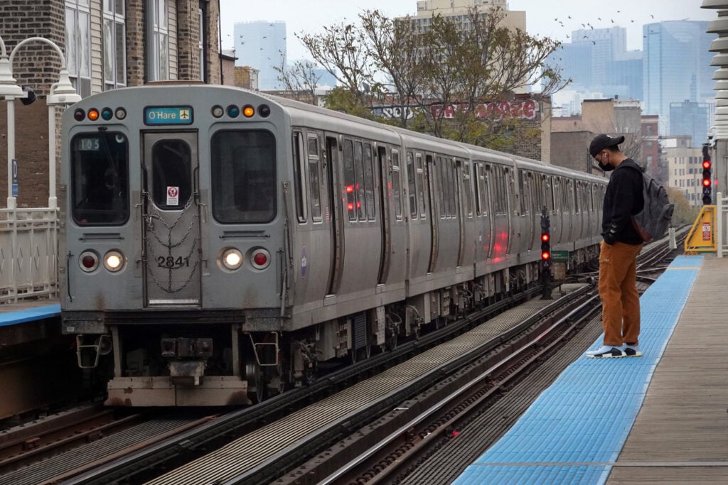 Passengers wait to board an L train at a station on November 09, 2021 in Chicago, Illinois. 
