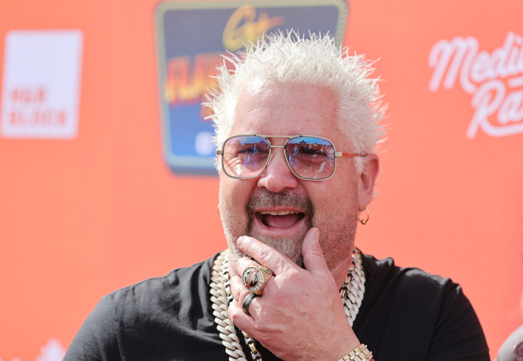 Guy Fieri is interviewed at Guy Fieri's Flavortown Tailgate on February 12, 2023 in Glendale, Arizona. 