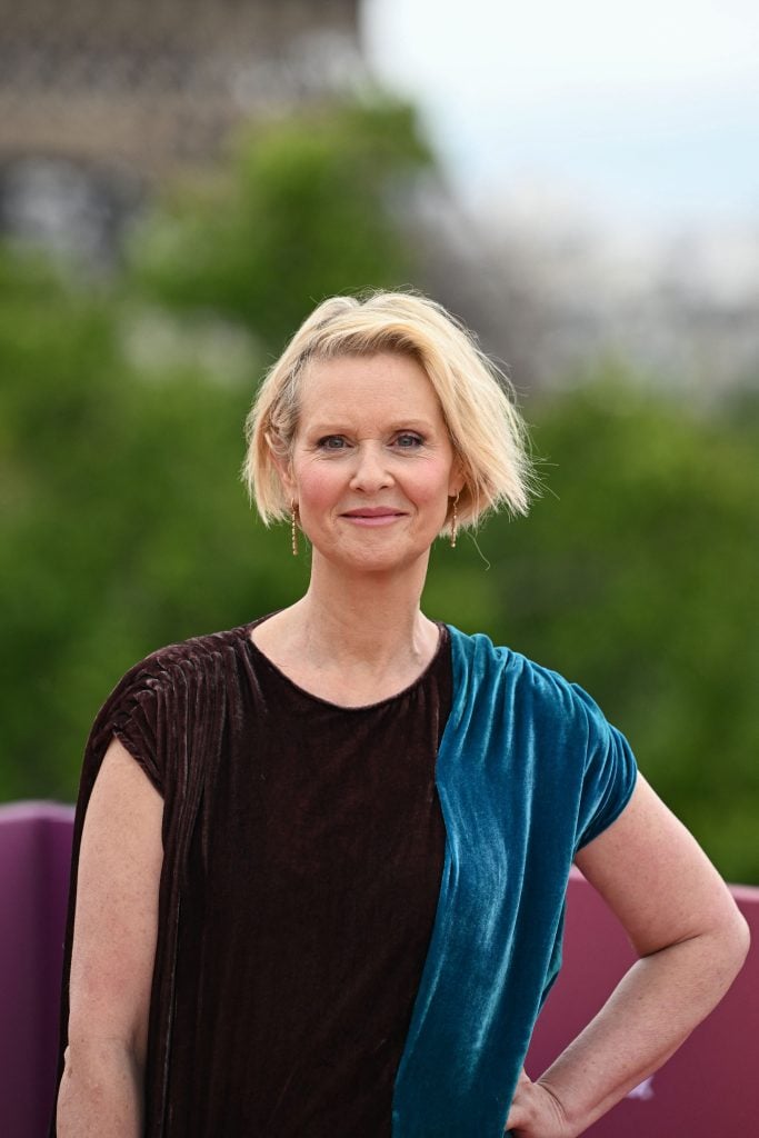 US actress Cynthia Nixon poses for pictures in front of the Eiffel Tower during a photocall for the TV serie And Just Like That... on a rooftop at France's Economic, Social and Environmental Council (CESE) in Paris, on May 28, 2025. 