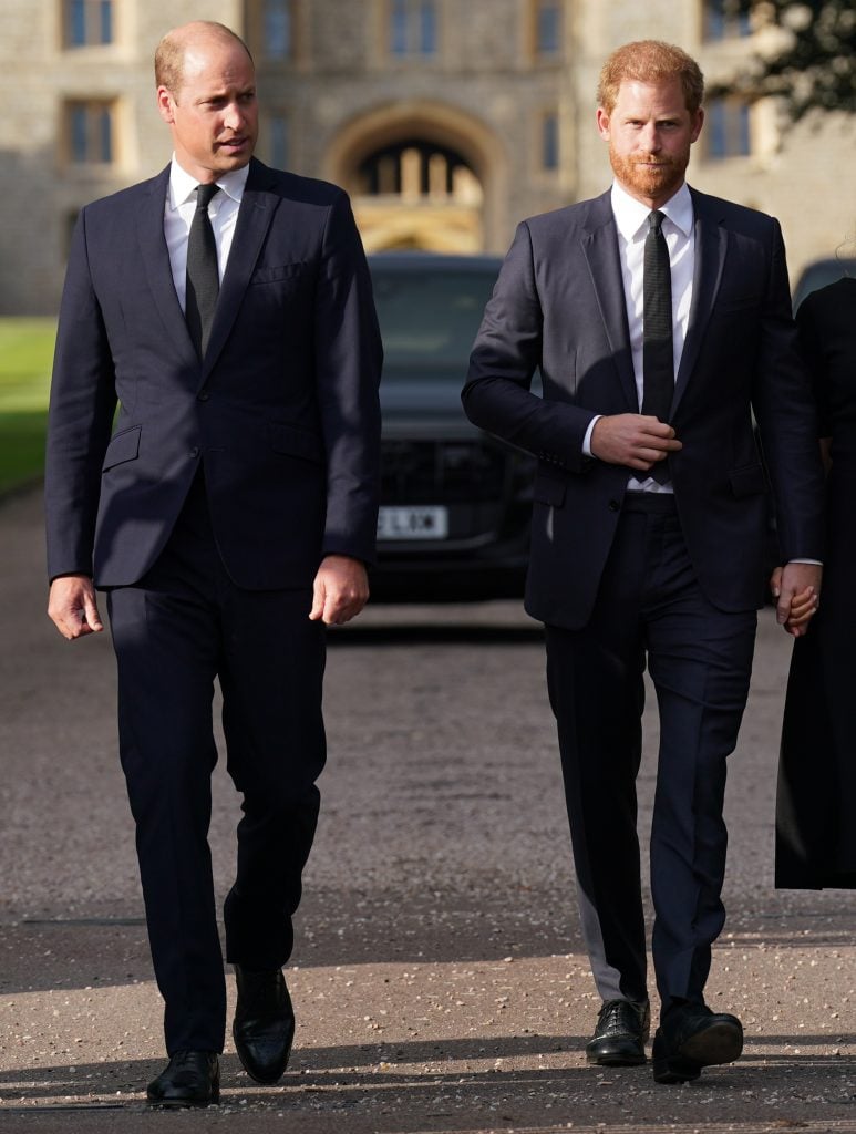 Prince William, Prince of Wales and Prince Harry, Duke of Sussex walk together to meet members of the public on the long Walk at Windsor Castle on September 10, 2022 in Windsor, England.