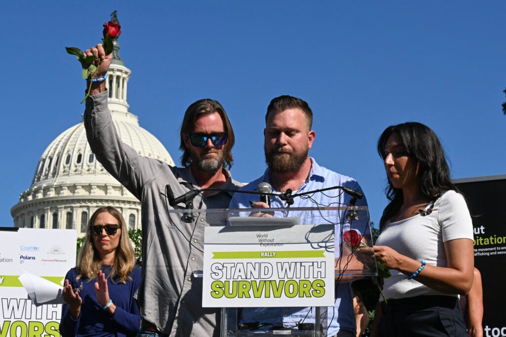 Family members of Virginia Roberts Duffey, Scott Roberts (C), his wife Amanda Roberts (R) and brother Daniel Wilson, speak at the Stand with Survivors Rally in support of Jeffrey Epstein and Ghislaine Maxwell's victims, in Washington, DC on September 3, 2025. 