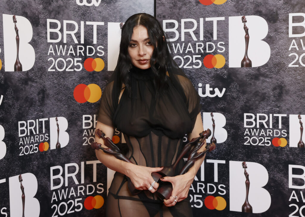 Charli XCX poses in the winners room with the awards for Artist of the Year, Song of the Year, Album of the Year and Dance Act during The BRIT Awards 2025 at The O2 Arena on March 01, 2025 in London, England.