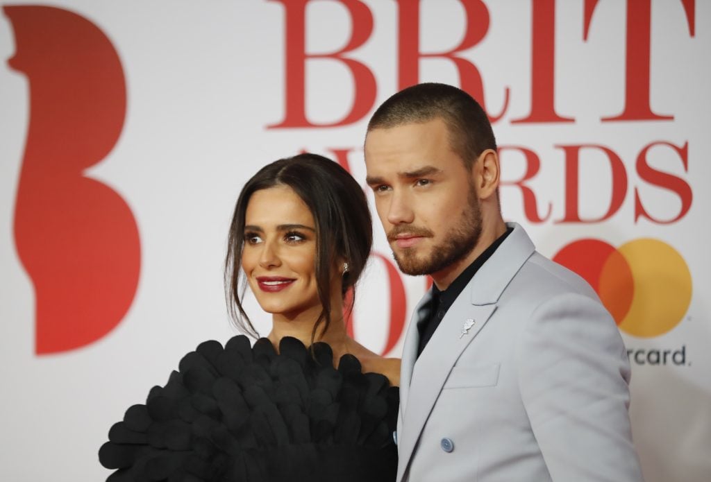British singer-songwriter Liam Payne and partner Cheryl pose on the red carpet on arrival for the BRIT Awards 2018 in London on February 21, 2018. 