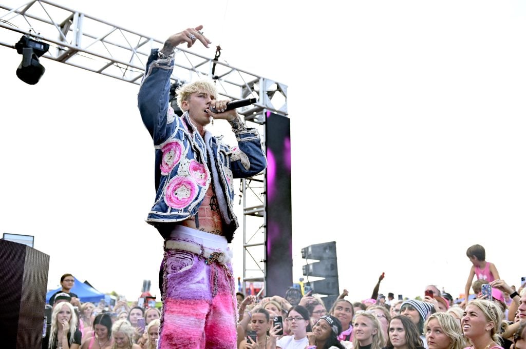 Machine Gun Kelly in August of 2023, on stage.