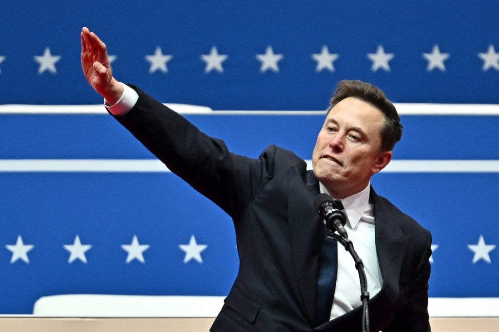 Elon Musk gestures as he speaks during the inaugural parade inside Capital One Arena, in Washington, DC, on January 20, 2025. 