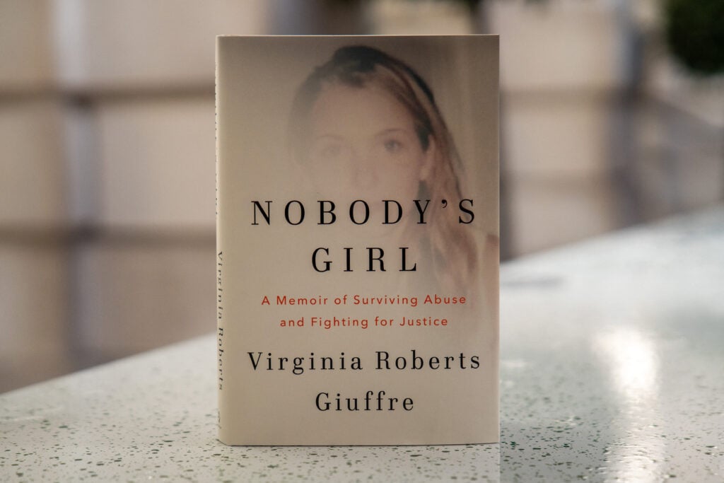 A copy of the book Nobody's Girl - A Memoir of Surviving Abuse and Fighting for Justice by Virginia Roberts Giuffre, is pictured in central London on October 21, 2025, on the day of its release in the UK.