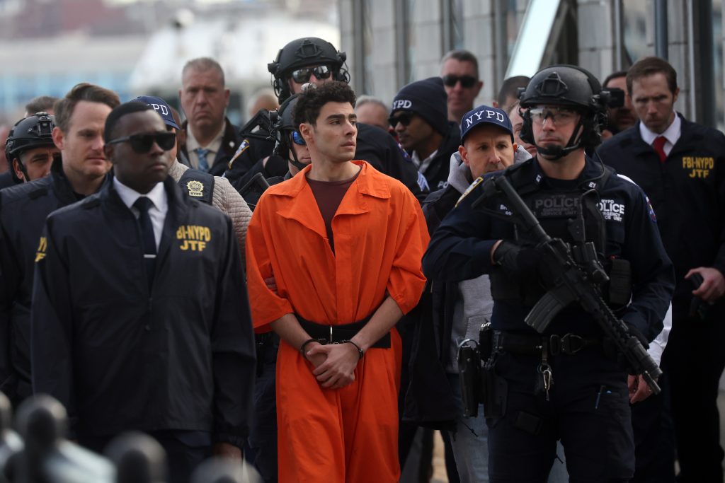 Luigi Mangione surrounded by police goons in December 2024.