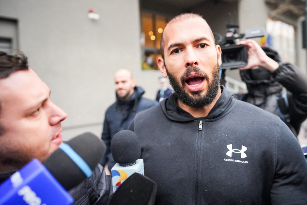British-US former professional kickboxer and controversial influencer Andrew Tate talks to media as he leaves Romania's anti-organized crime and terrorism directorate (DIICOT), after a digital investigation of devices, where his presence was required, in Bucharest, Romania on January 25, 2023.