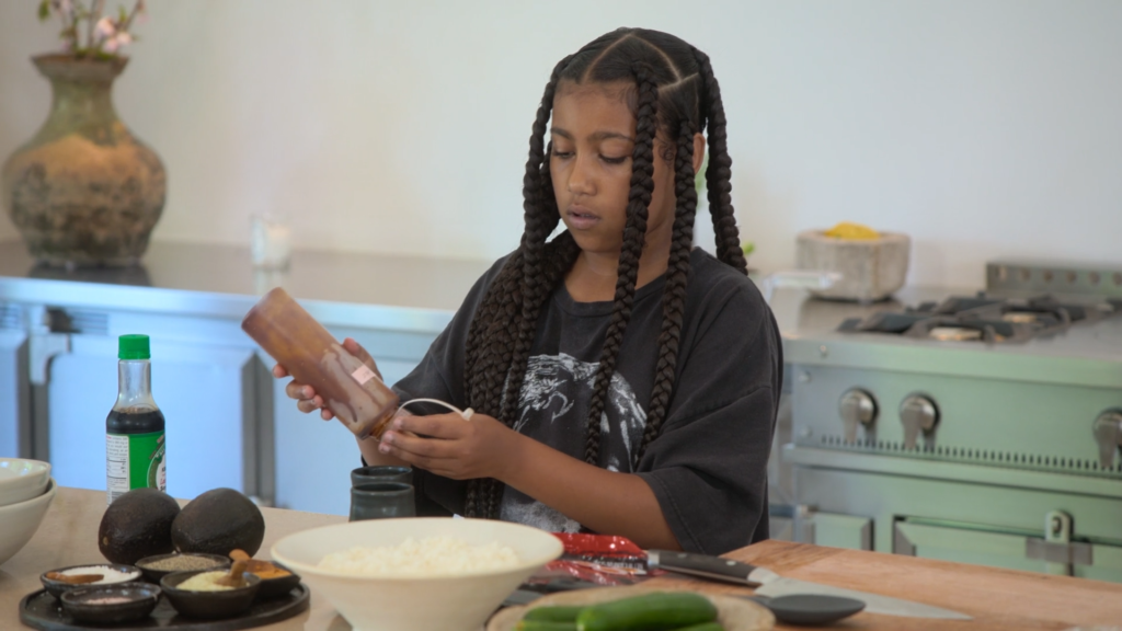North West prepares food in her mother's spacious, hauntingly minimalist kitchen. North West prepares food in her mother's spacious, hauntingly minimalist kitchen.
