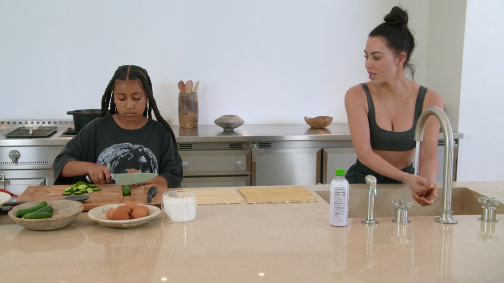 North West and Kim Kardashian both work at the kitchen counter. North West and Kim Kardashian both work at the kitchen counter.