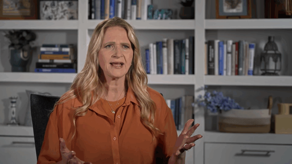 Christine Brown gestures at the camera. Christine Brown gestures at the camera.