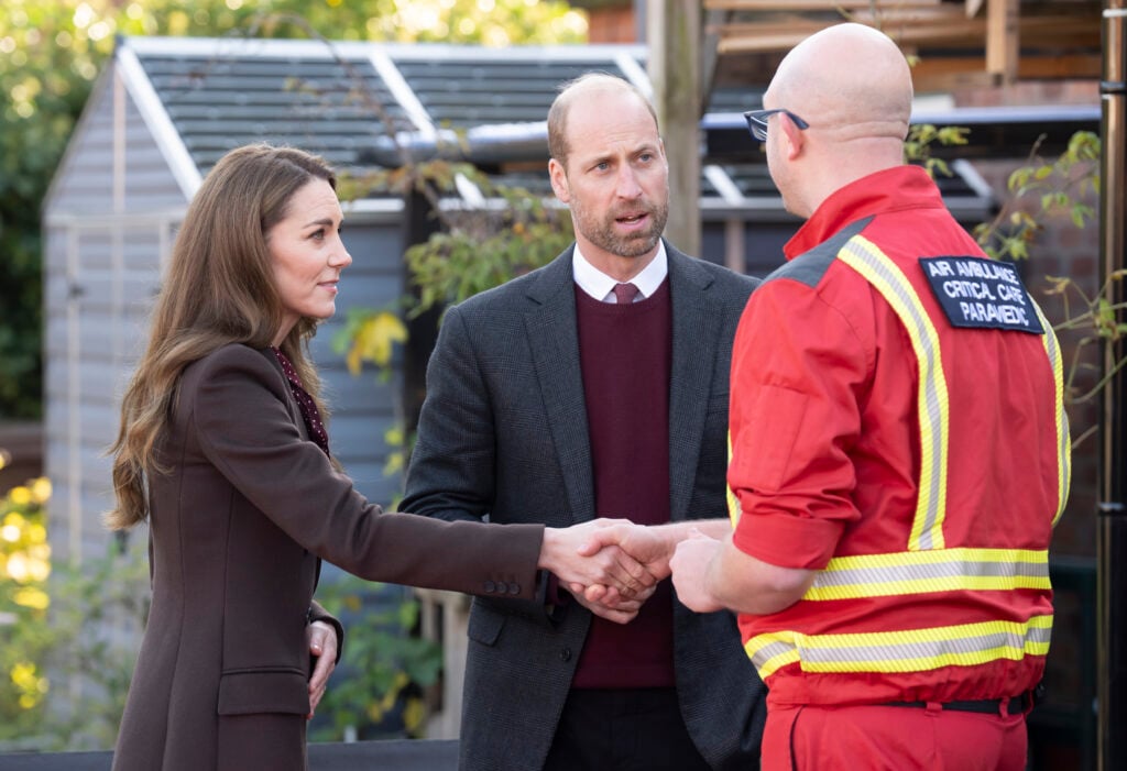 Prince William, Prince of Wales and Catherine, Princess of Wales speak with members of the Emergency Services during a visit to Southport Community Centre on October 10, 2024 in Southport, England.