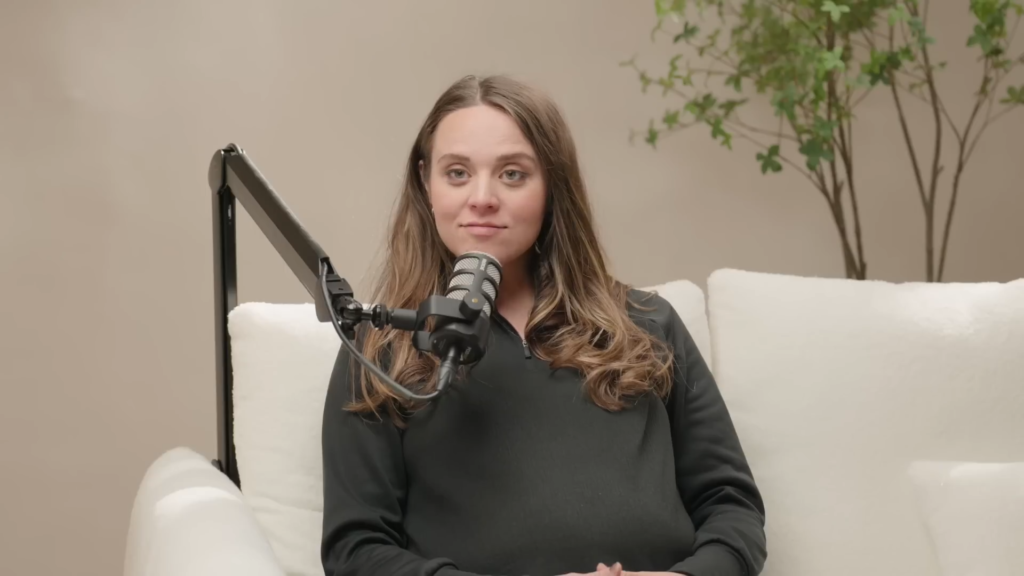 Jinger Duggar speaks into the podcast mic on her podcast in December 2024.