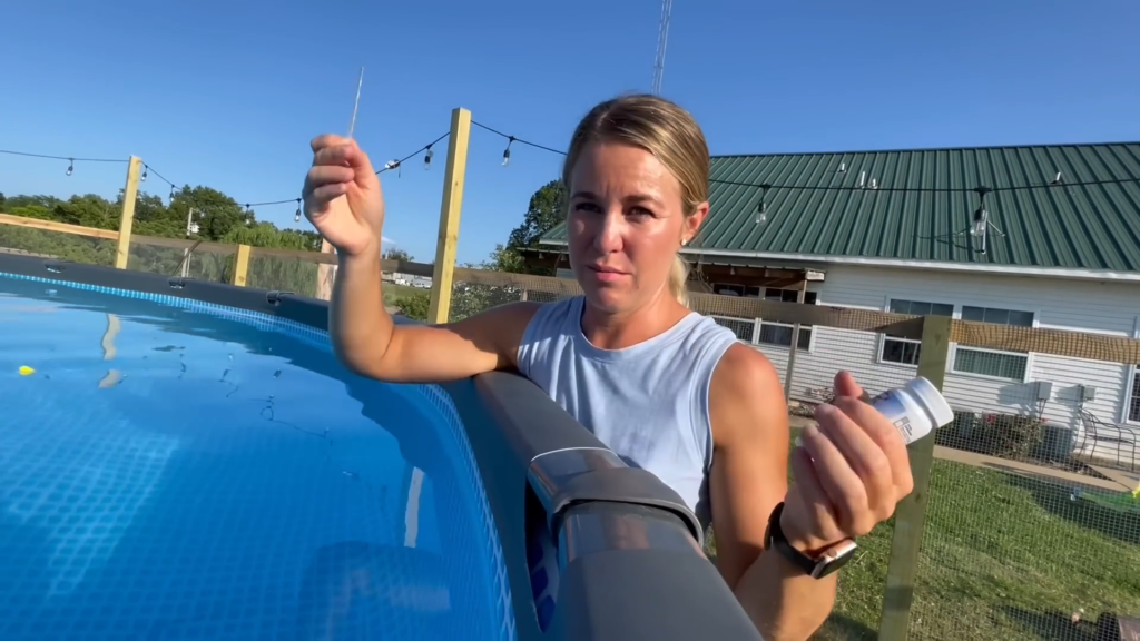 Jana Duggar by her above-ground pool, baring her arms.