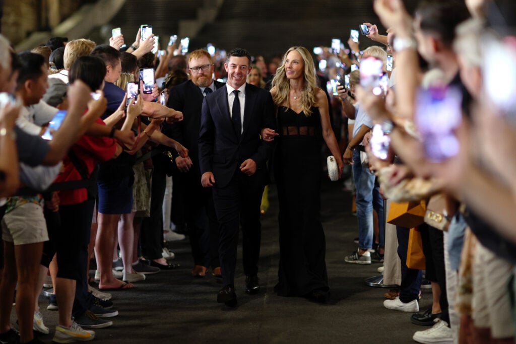 Rory McIlroy of Team Europe and wife Erica Stoll walk through fans at the Spanish Steps prior to the 2023 Ryder Cup at Marco Simone Golf Club on September 27, 2023 in Rome, Italy.