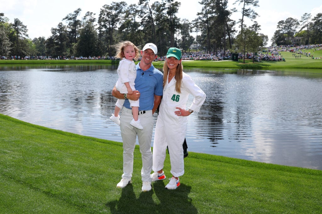 Rory McIlroy of Northern Ireland poses for a photo with his wife, Erica Stoll and daughter Poppy McIlroy during the Par 3 contest prior to the 2023 Masters Tournament at Augusta National Golf Club on April 05, 2023 in Augusta, Georgia.