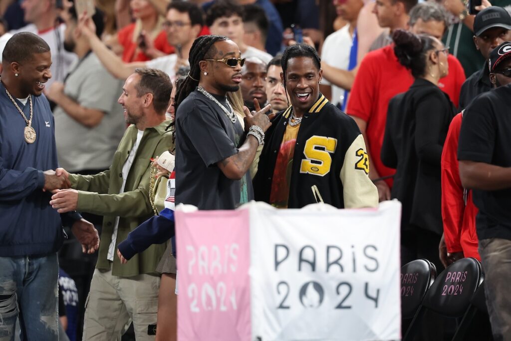 Rappers Quavo (L) and Travis Scott attend the Men's basketball semifinals match between Team United States and Team Serbia on day thirteen of the Olympic Games Paris 2024 at Bercy Arena on August 08, 2024 in Paris, France. 