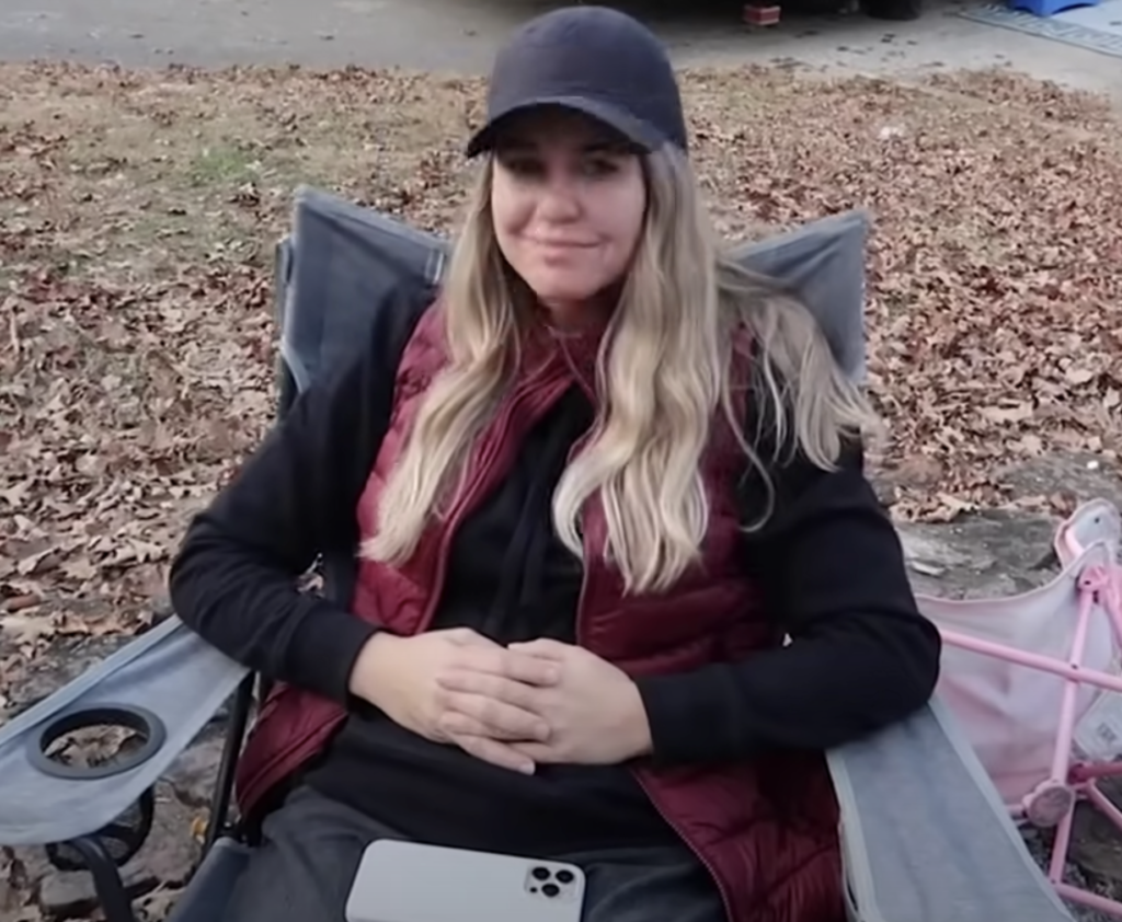 Jana Duggar smiles at the camera during a camping trip.