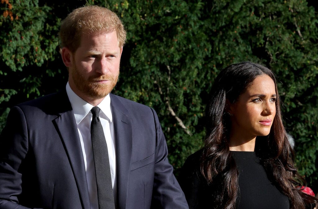 Prince Harry, Duke of Sussex, and Meghan, Duchess of Sussex on the long Walk at Windsor Castle arrive to view flowers and tributes to HM Queen Elizabeth on September 10, 2022 in Windsor, England. 